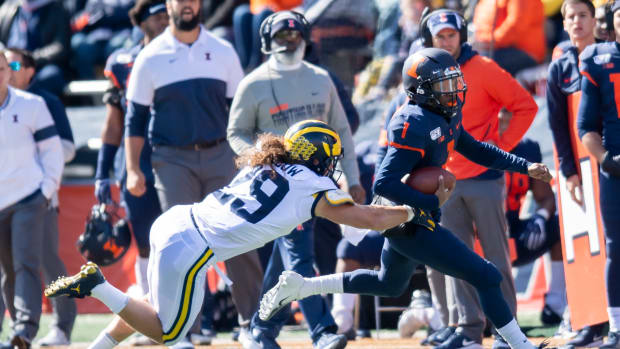 Michigan linebacker Jordan Glasgow (29) tackles Illinois quarterback Isaiah Williams (1) during the first half of Michigan's 42-25 win at Memorial Stadium.